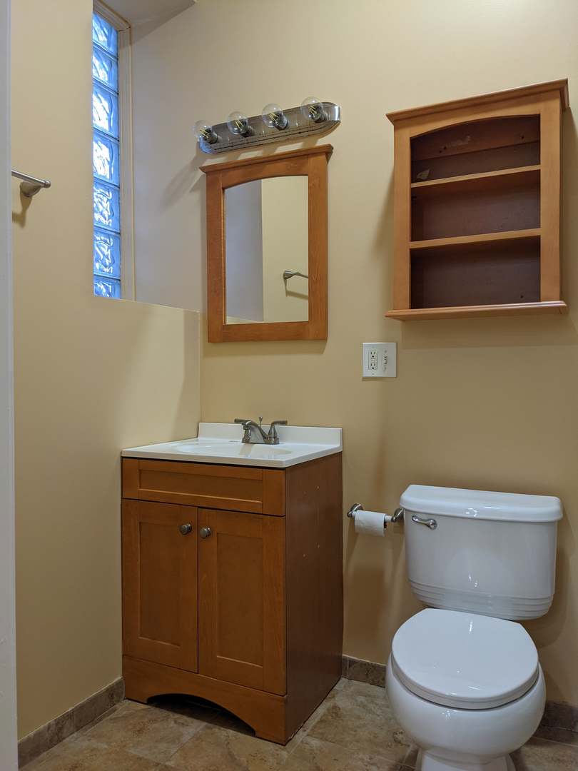 712 South Aberdeen Street, Unit 1A Chicago, IL 60607 - Photo 14 of 28 a bathroom with a toilet a sink and mirror