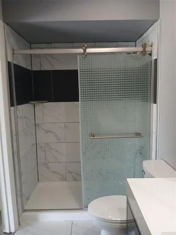 a bathroom with a shower and a toilet