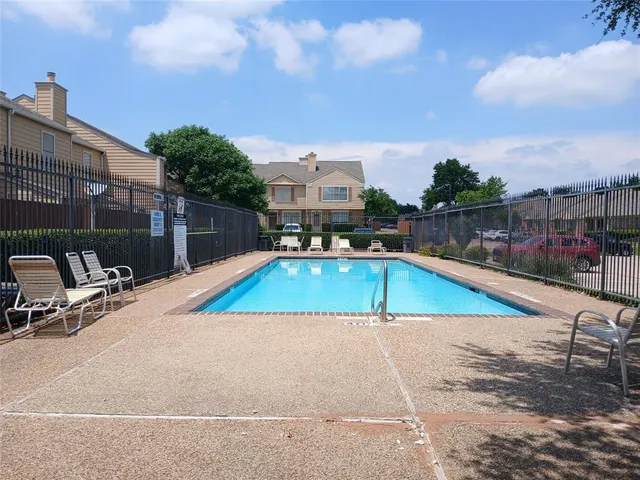 a view of a swimming pool with a lounge chairs