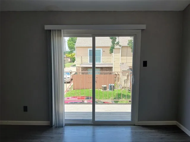 a view of an entryway with wooden floor