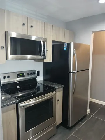 a kitchen with a stove microwave and refrigerator