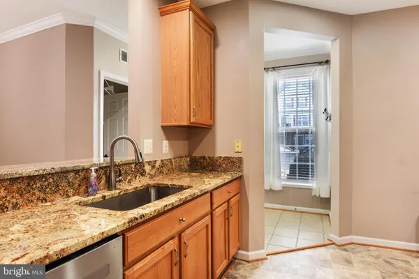 a view of a kitchen with a sink and cabinets