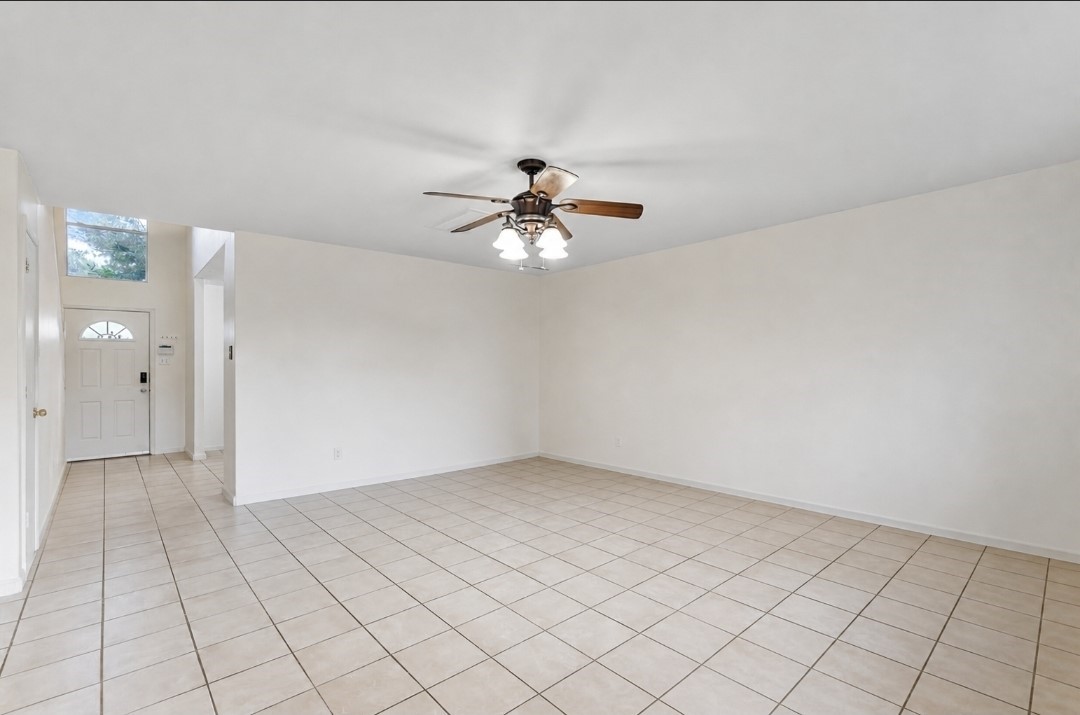 11430 Moonlight Ridge Drive Humble, TX 77396 - Photo 4 of 15 an empty room with chandelier fan and windows