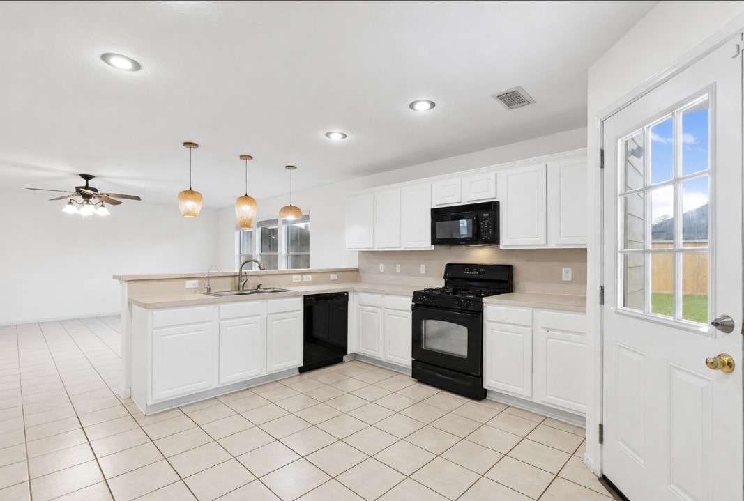 11430 Moonlight Ridge Drive Humble, TX 77396 - Photo 7 of 15 a kitchen with granite countertop white cabinets and stainless steel appliances