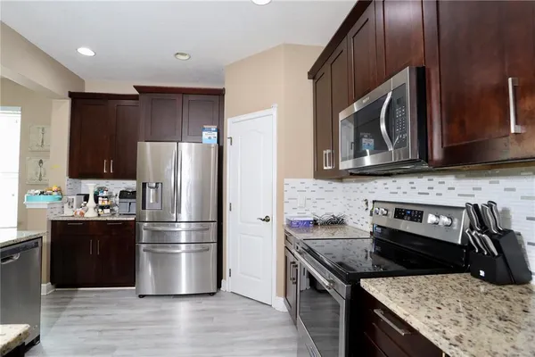 a kitchen with a refrigerator stove and microwave