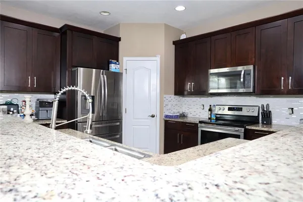 a kitchen with a refrigerator stove and microwave