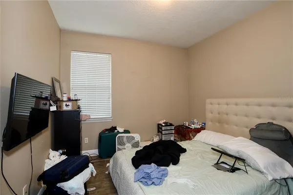 a bedroom with a bed and a chair