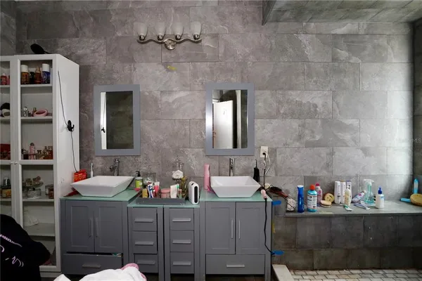 a bathroom with a sink mirror and vanity