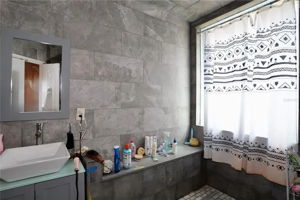 a view of a bedroom with furniture and a window