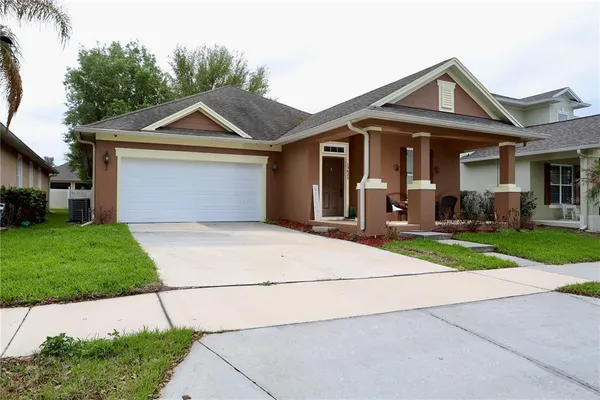 a front view of house with yard and outdoor seating
