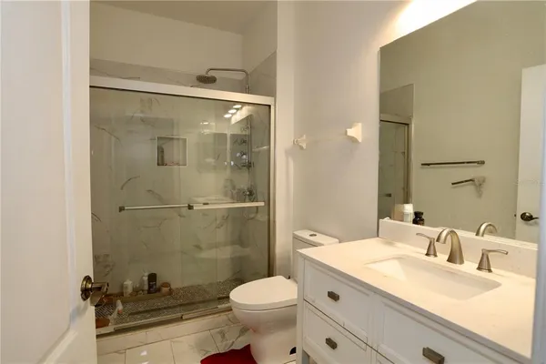 a bathroom with a sink toilet and shower
