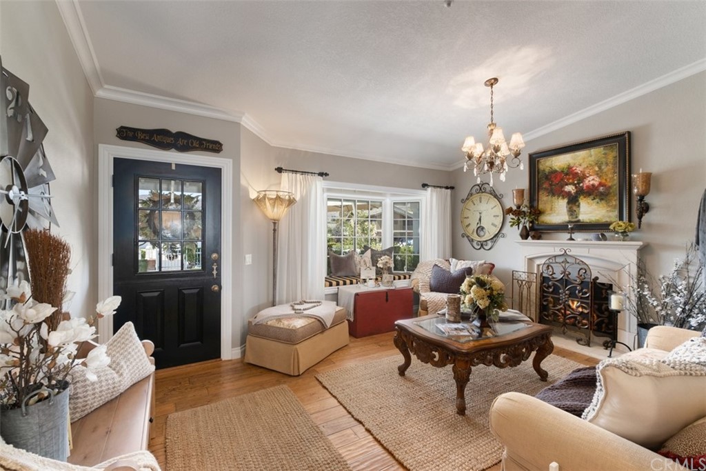 2933 Estancia San Clemente, CA 92673 - Photo 11 of 59 a living room with furniture a chandelier and a flat screen tv