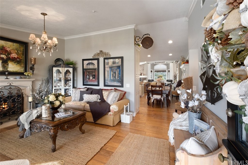 2933 Estancia San Clemente, CA 92673 - Photo 13 of 59 a living room with fireplace furniture and a chandelier