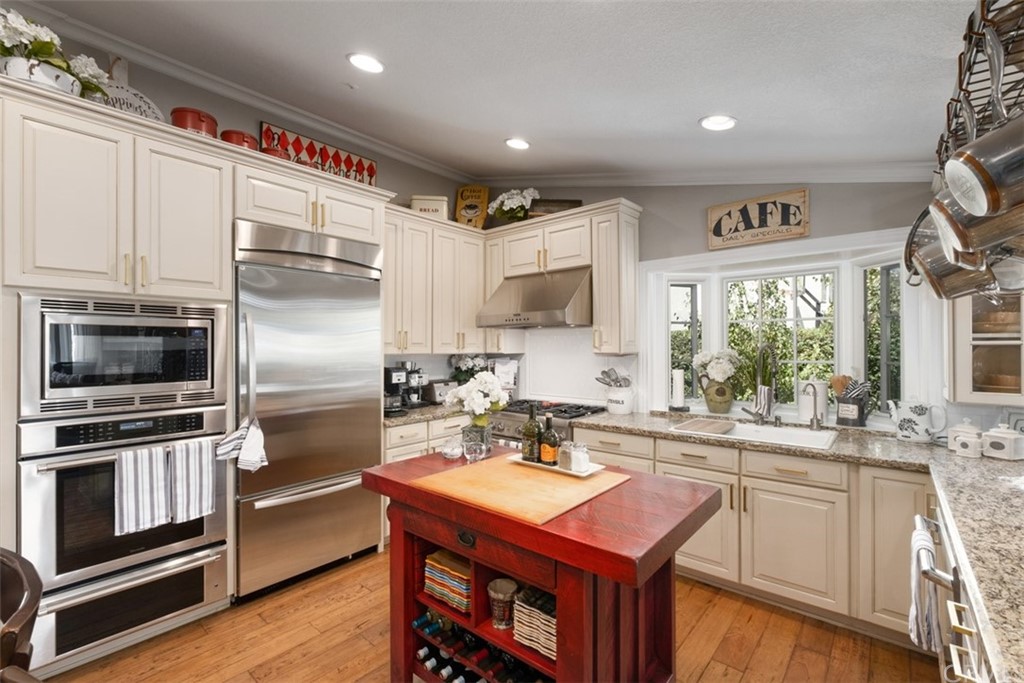 2933 Estancia San Clemente, CA 92673 - Photo 18 of 59 a kitchen with kitchen island a counter top space a sink appliances and cabinets