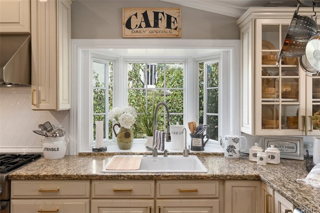 2933 Estancia San Clemente, CA 92673 - Photo 19 of 59 a kitchen with granite countertop a sink and a window