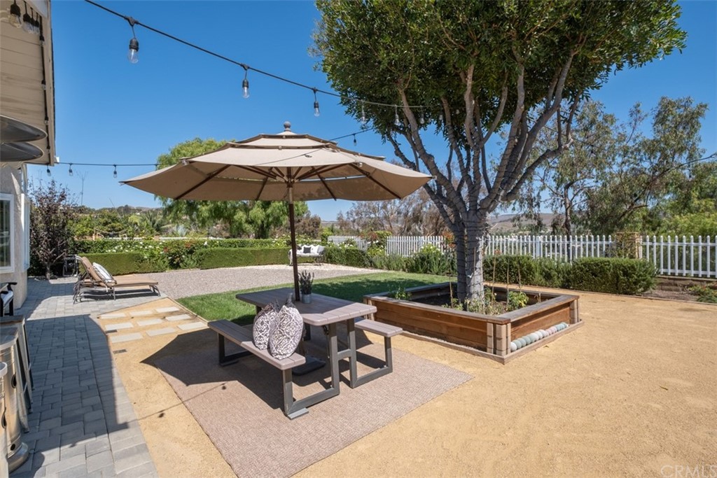 2933 Estancia San Clemente, CA 92673 - Photo 42 of 59 a view of a patio with a table chairs and a fire pit