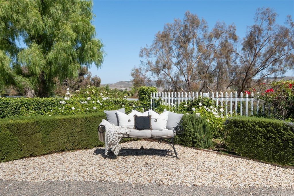 2933 Estancia San Clemente, CA 92673 - Photo 43 of 59 a bench sitting in middle of a garden