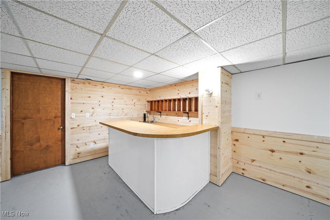 3111 Blake Road Ashtabula, OH 44004 - Photo 26 of 39 Kitchen featuring a paneled ceiling, wooden walls, and kitchen peninsula