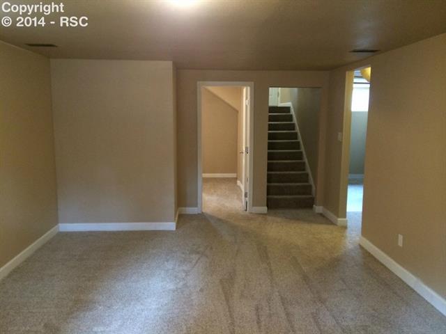 838 East Rio Grande Street Colorado Springs, CO 80903 - Photo 19 of 25 Family room looking toward 3 bedroom, stairs, and laundry room