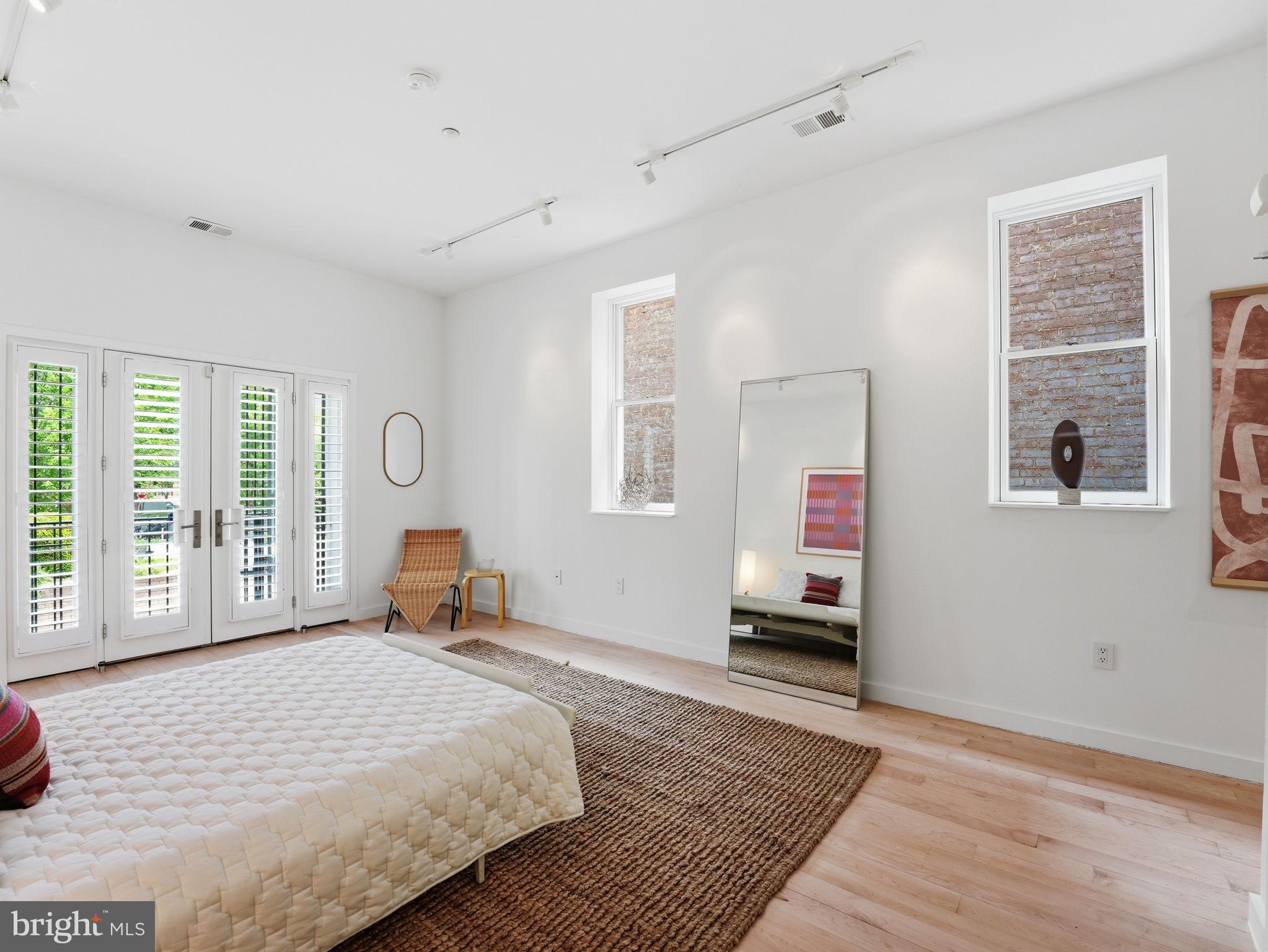1845 Calvert Street Northwest Washington, DC 20009 - Photo 41 of 48 a bedroom with a bed and wooden floor