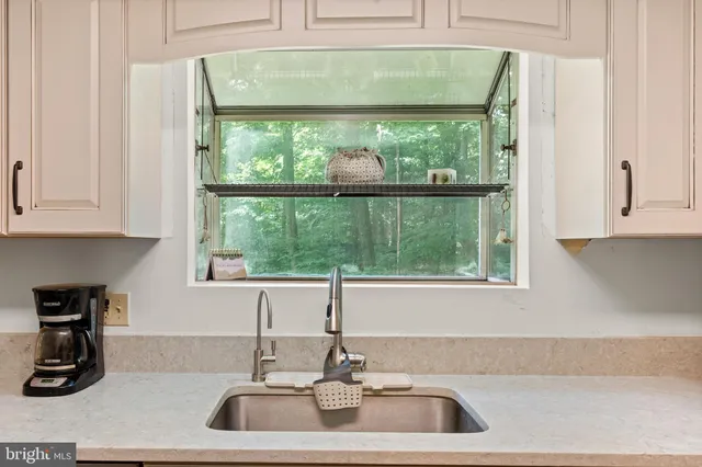 a kitchen with a sink and a window