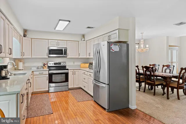a kitchen with stainless steel appliances a refrigerator stove microwave and sink