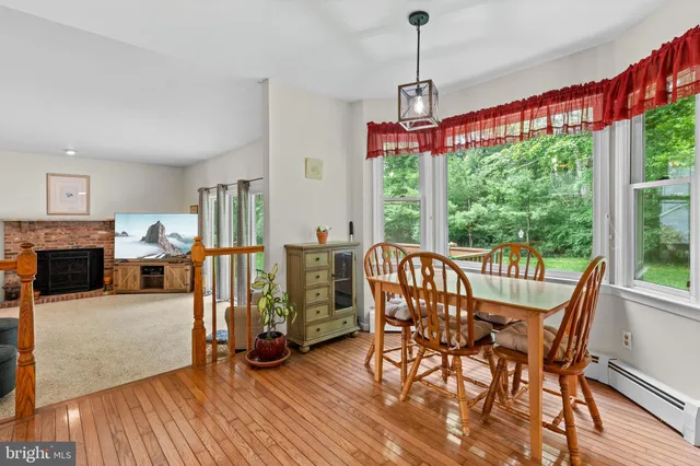 a view of a dining room with furniture window and wooden floor
