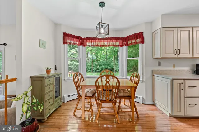 a dining room with furniture a chandelier and wooden floor