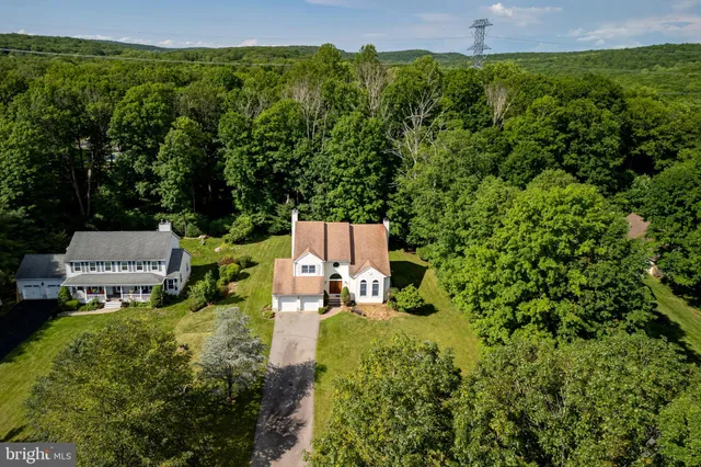 an aerial view of a house with pool yard and outdoor seating