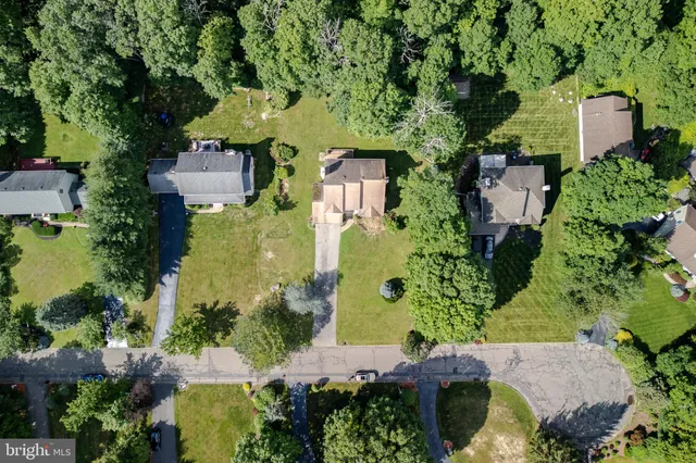 an aerial view of a house with a yard and swimming pool