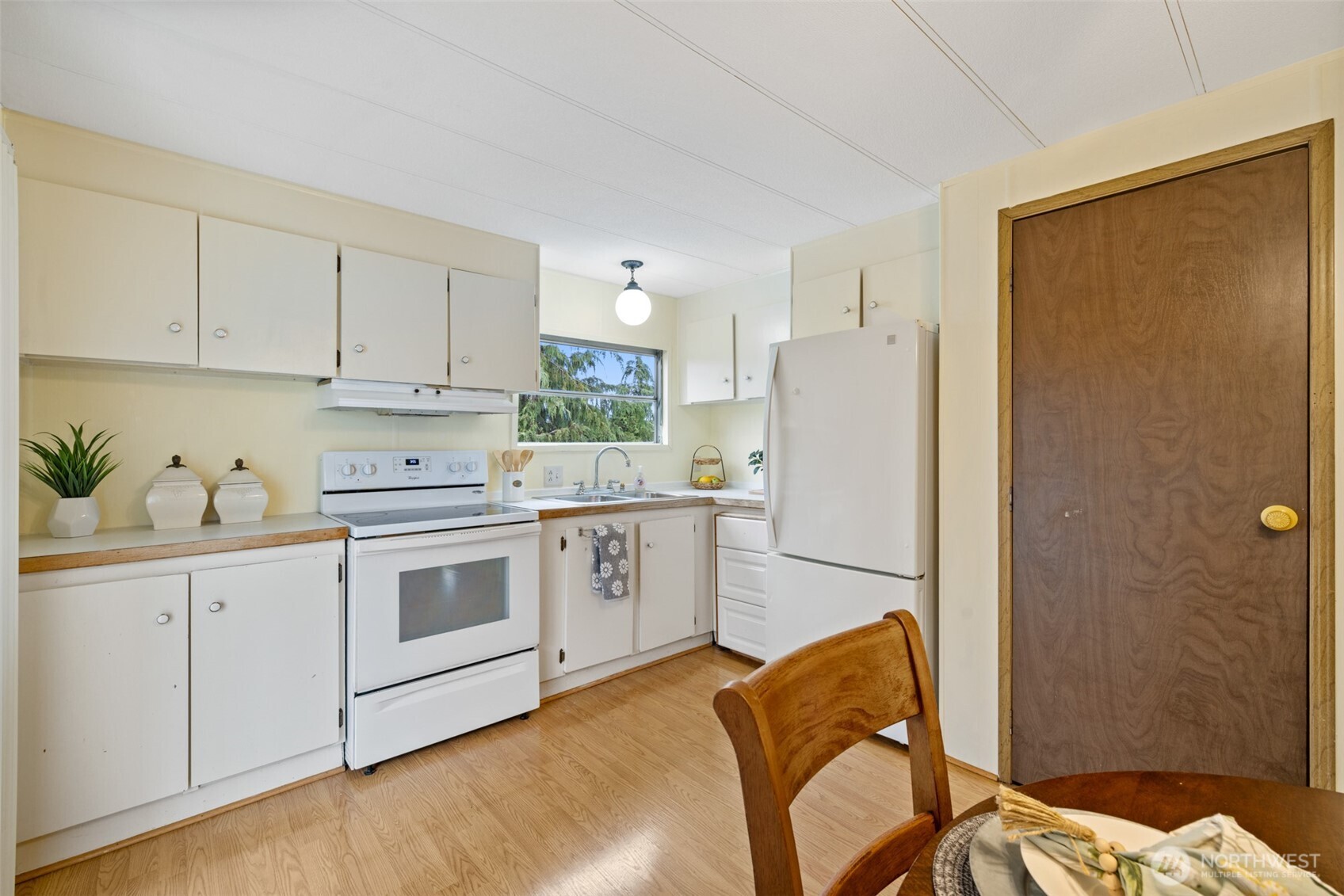 11 Juniper Mobile Estate Sequim, WA 98382 - Photo 11 of 31 a kitchen with stainless steel appliances granite countertop a refrigerator sink and white cabinets