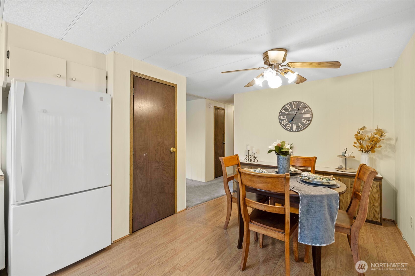 11 Juniper Mobile Estate Sequim, WA 98382 - Photo 14 of 31 a view of a dining room with furniture and a refrigerator