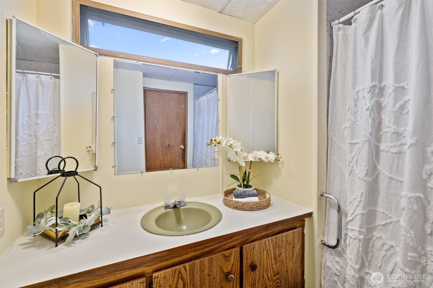 11 Juniper Mobile Estate Sequim, WA 98382 - Photo 19 of 31 a bathroom with a sink and a mirror