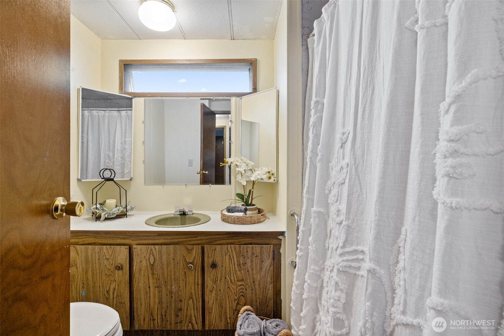 11 Juniper Mobile Estate Sequim, WA 98382 - Photo 21 of 31 a bathroom with a granite countertop sink and a mirror