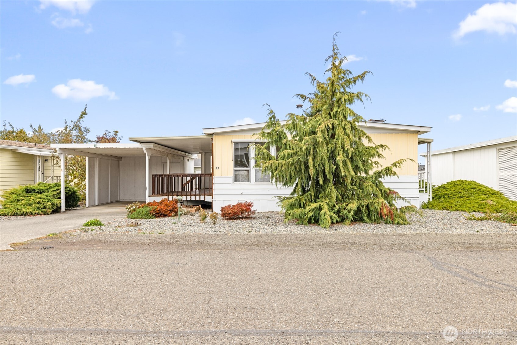 11 Juniper Mobile Estate Sequim, WA 98382 - Photo 3 of 31 a view of a house with a patio and a yard