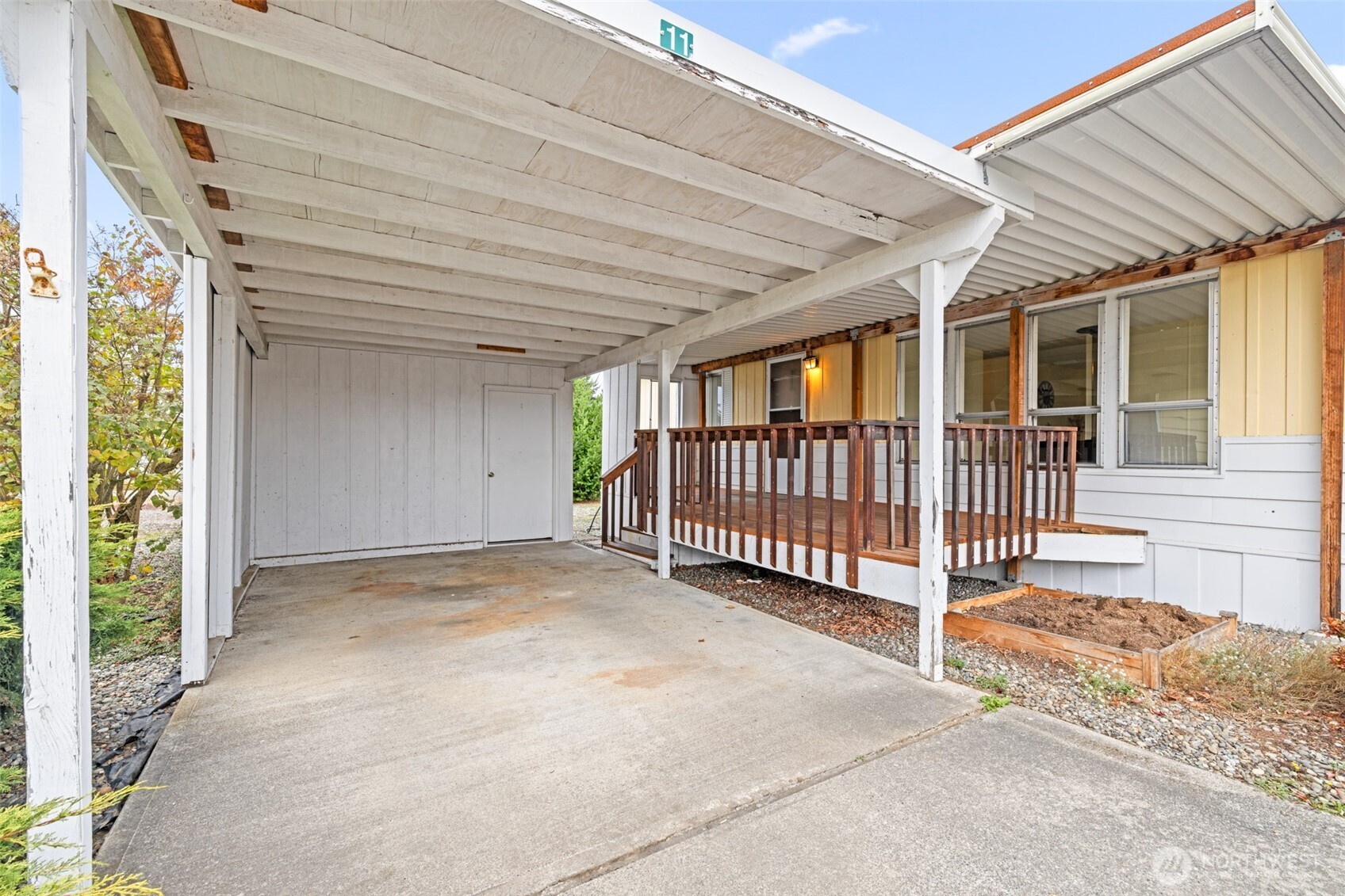 11 Juniper Mobile Estate Sequim, WA 98382 - Photo 4 of 31 a view of a house with porch and wooden floor