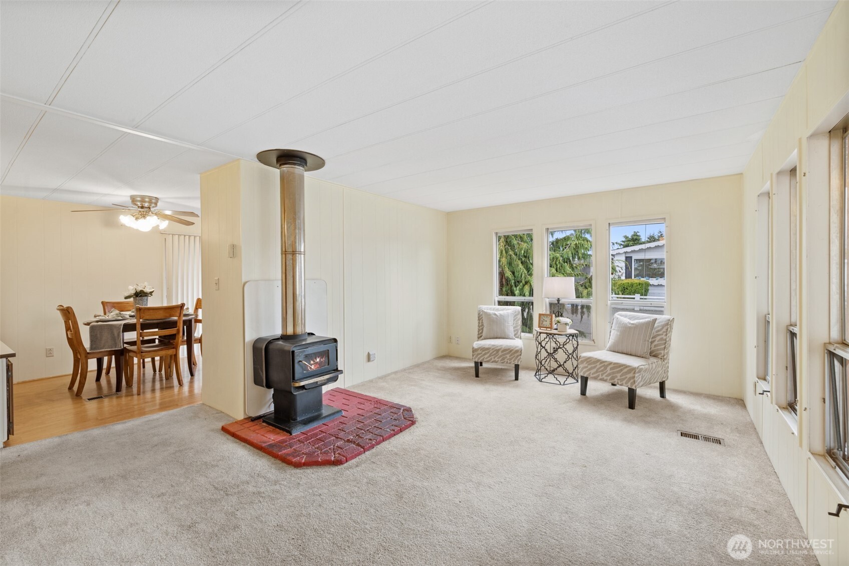 11 Juniper Mobile Estate Sequim, WA 98382 - Photo 7 of 31 a living room with furniture a large window and potted plants
