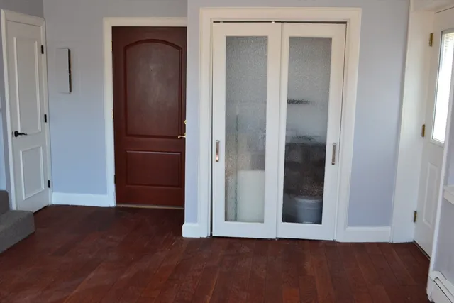 an empty room with wooden floor and closet