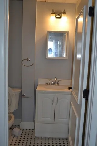 a white toilet sitting next to a shower