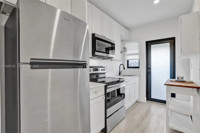 a kitchen with stainless steel appliances a refrigerator stove and microwave