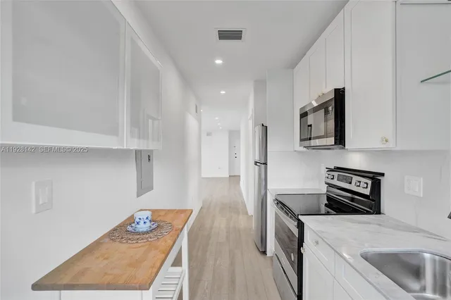 a kitchen with a sink a stove and refrigerator