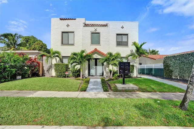 a front view of house with yard and green space