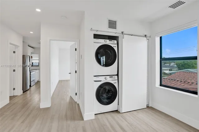 a view of a hallway with washer and dryer