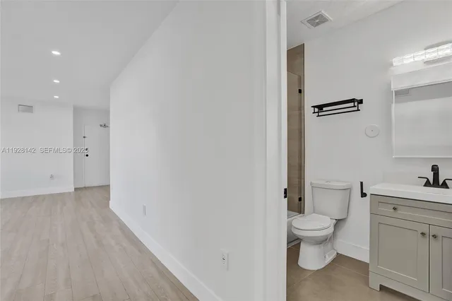 a bathroom with a toilet sink and a mirror