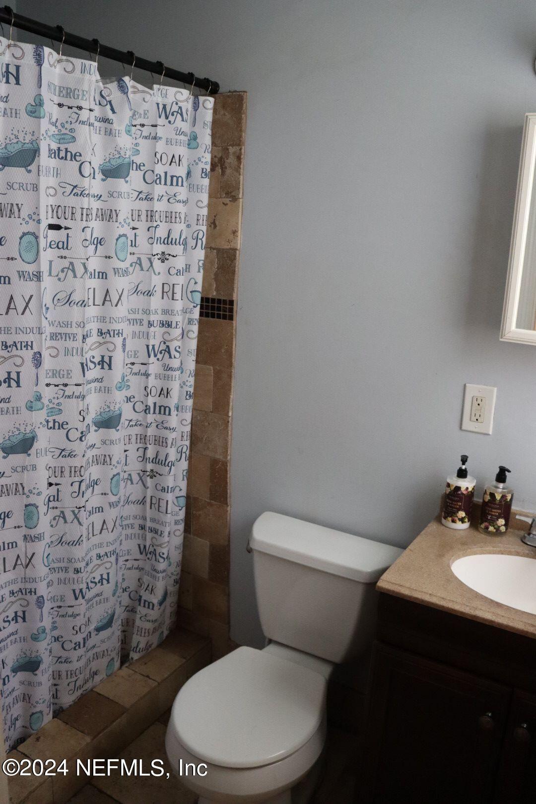 7351 Wheat Road Jacksonville, FL 32244 - Photo 12 of 15 a bathroom with a toilet and a shower