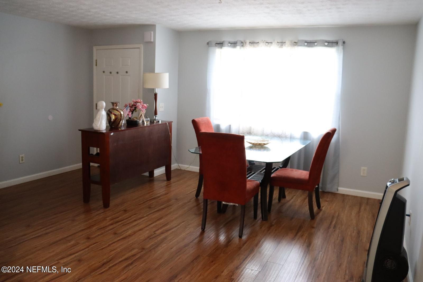7351 Wheat Road Jacksonville, FL 32244 - Photo 3 of 15 a view of a dining room with furniture and wooden floor