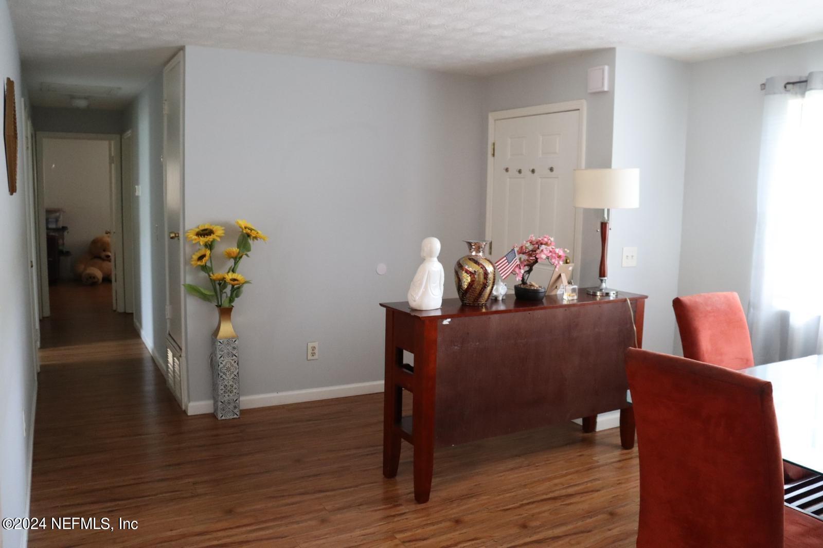 7351 Wheat Road Jacksonville, FL 32244 - Photo 4 of 15 a living room with furniture and wooden floor