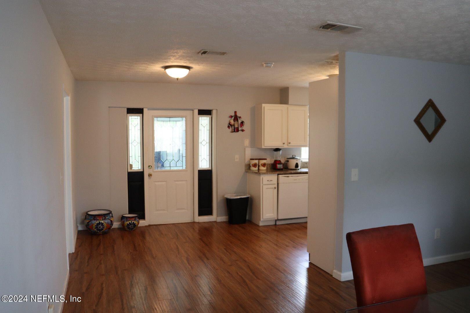 7351 Wheat Road Jacksonville, FL 32244 - Photo 5 of 15 a view of a room with wooden floor and furniture