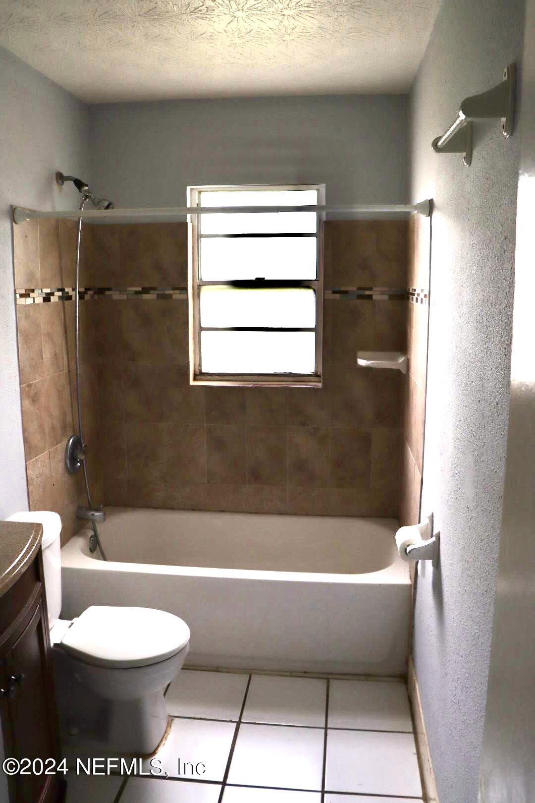 7351 Wheat Road Jacksonville, FL 32244 - Photo 8 of 15 a bathroom with a bathtub and a toilet