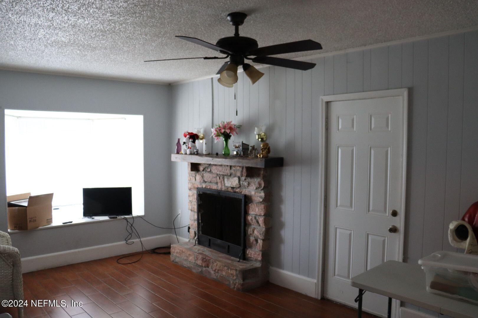 7351 Wheat Road Jacksonville, FL 32244 - Photo 9 of 15 a living room with furniture and a fireplace